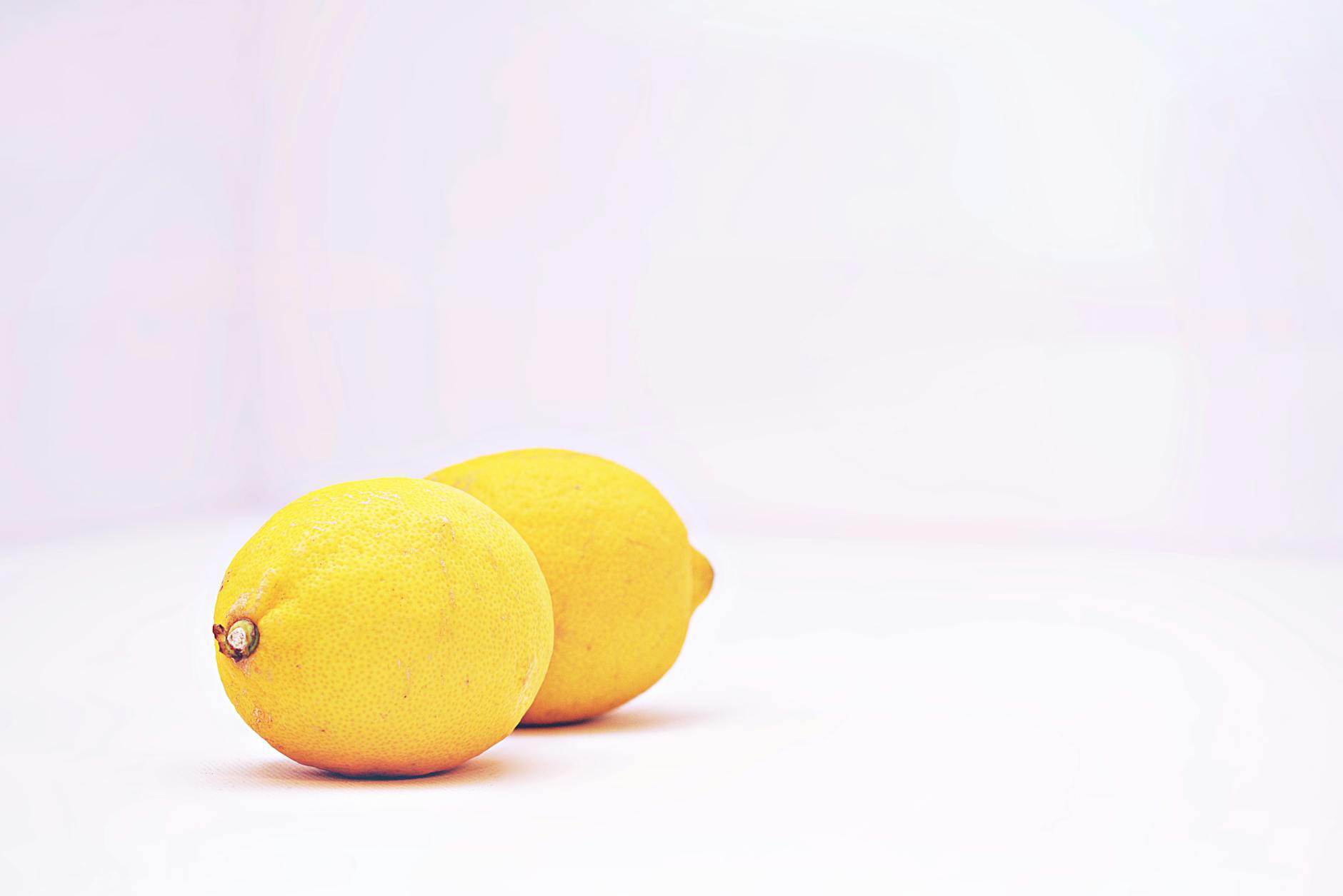 Two vibrant lemons on a white background symbolizing the lemon vibrator's fresh approach to clitoral stimulation