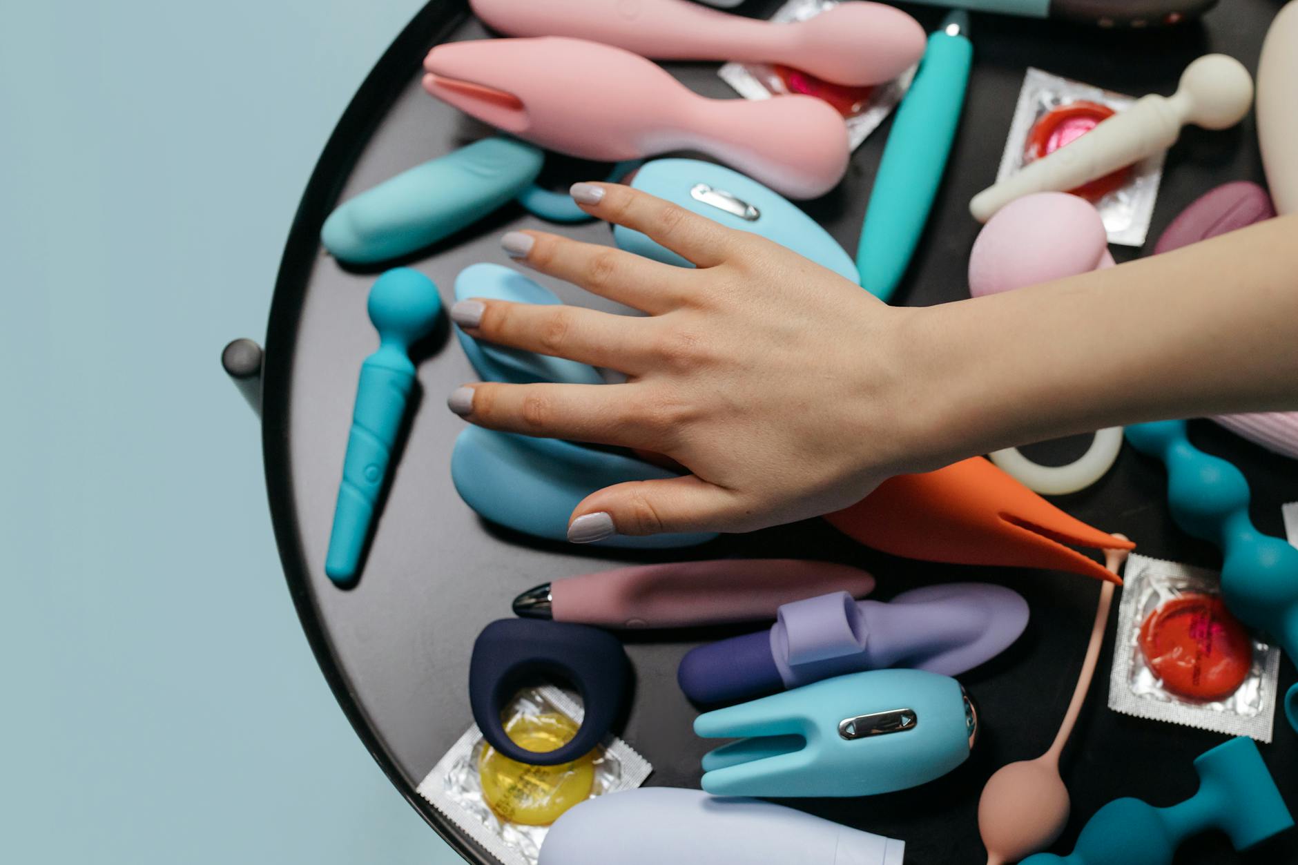 Woman holding a vibrator, reconnecting with her body after breakup