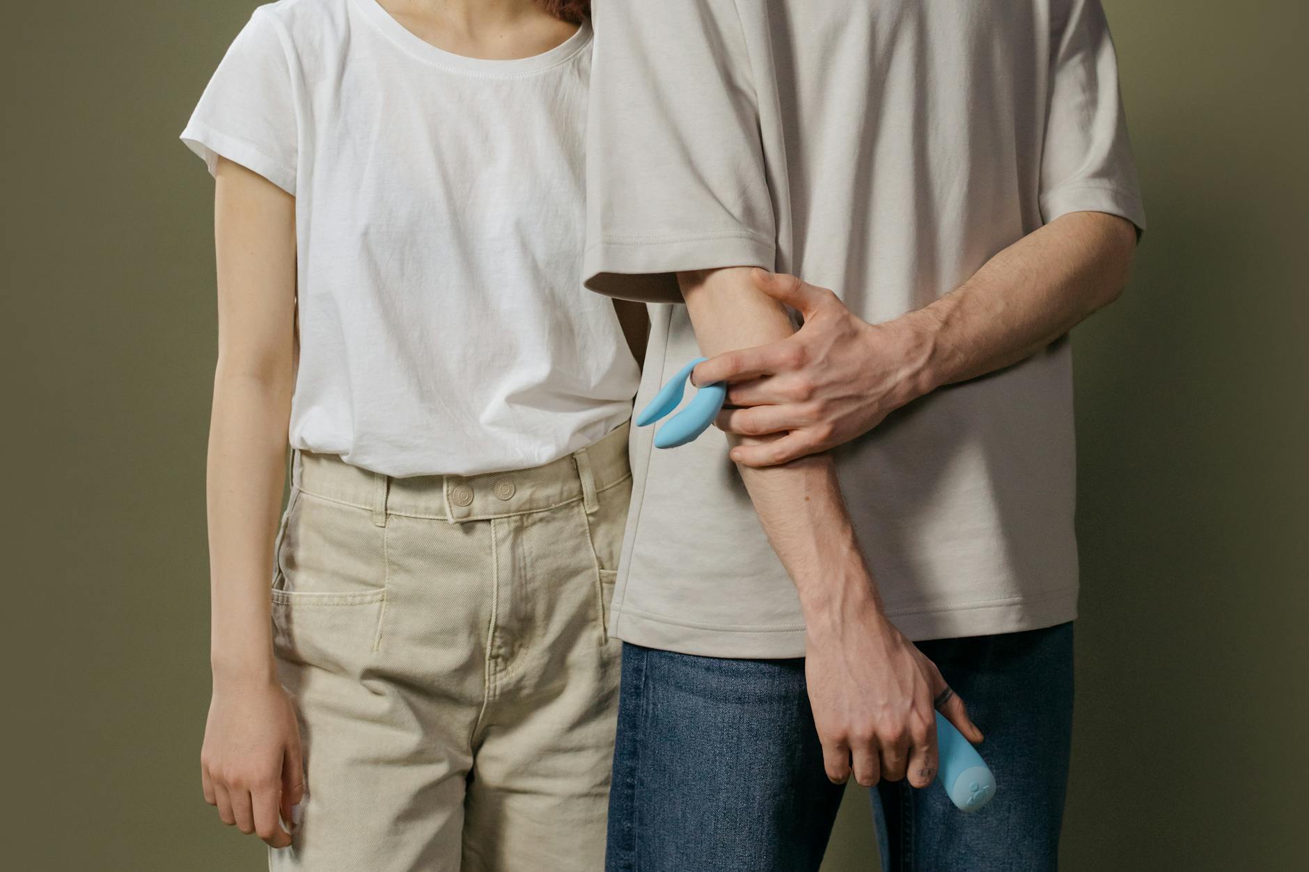 A young couple standing together indoors, exploring intimacy with modern toy design