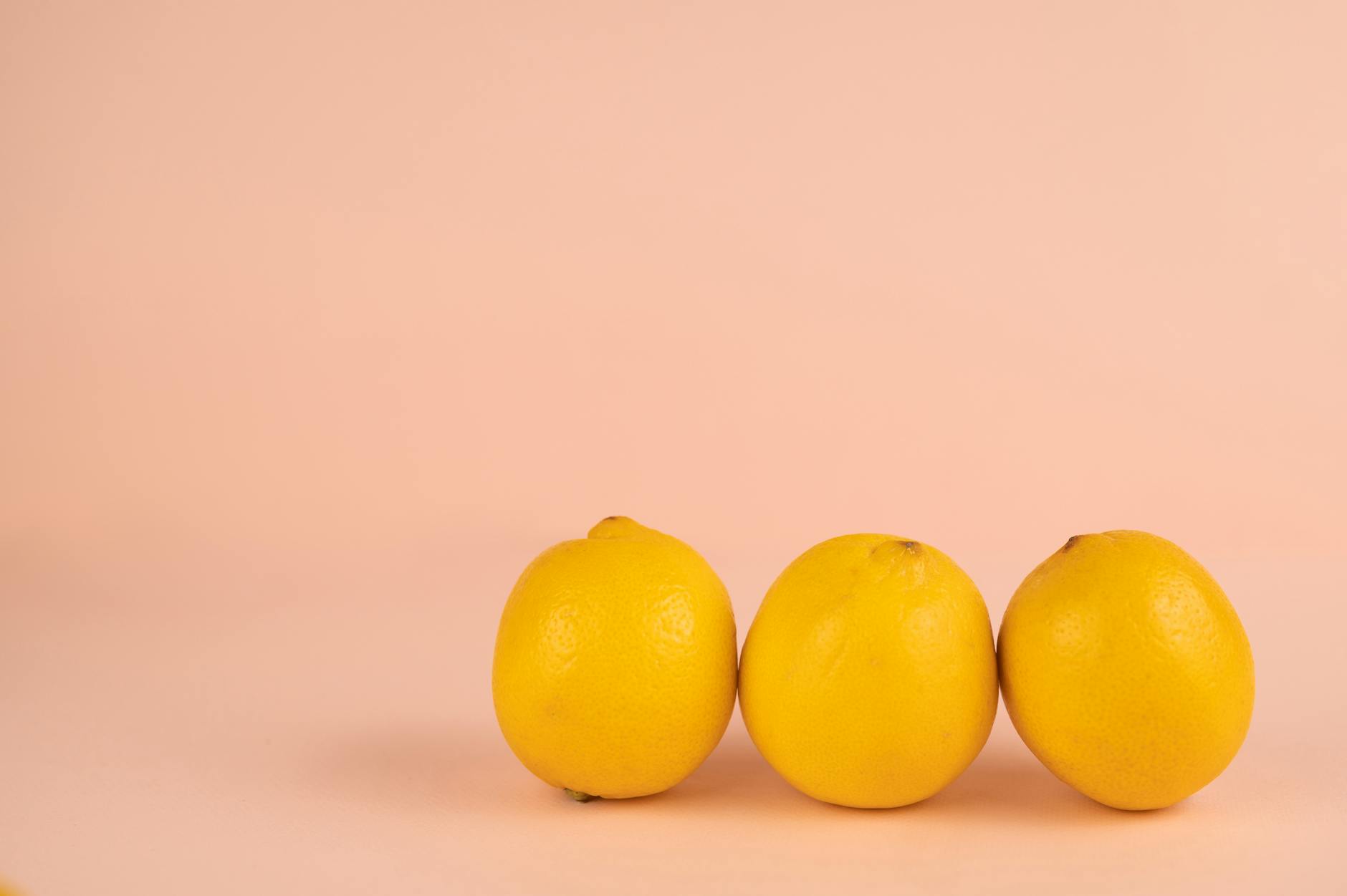 Bright ripe lemons arranged on a soft pastel background, symbolizing renewal and fresh starts